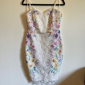 White dress with floral lace and multi-color detail along the sides